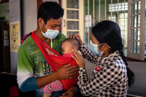 Ma Sabai, 24, who was born with HIV and diagnosed at 17, with her family at MSF’s clinic. 