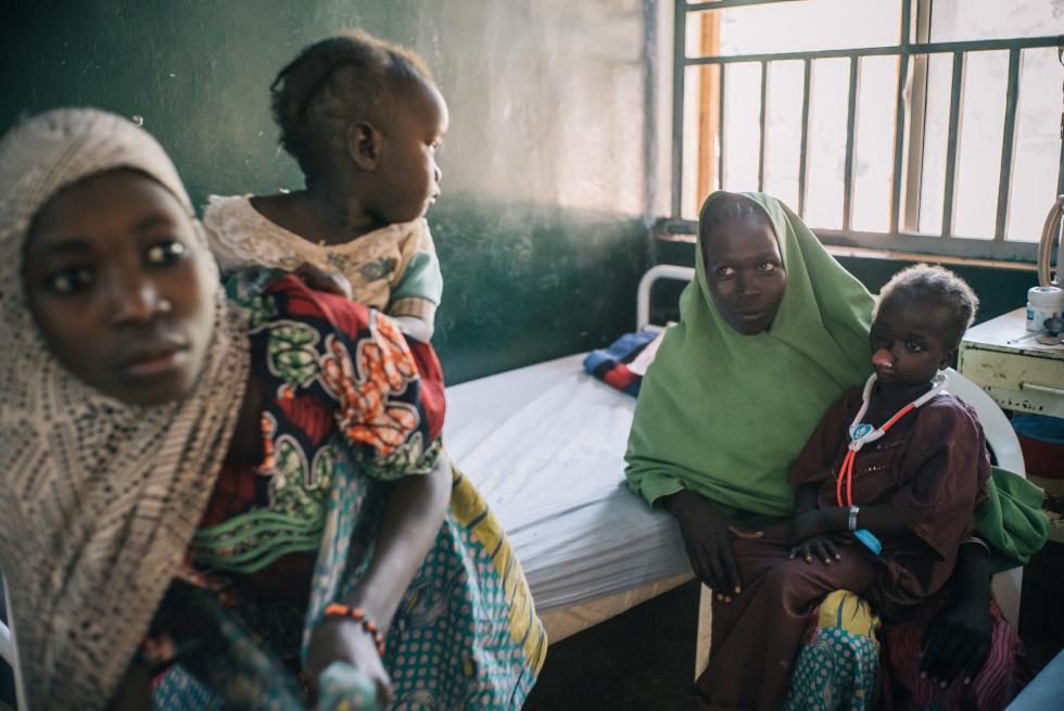  Yaashe, a six-year-old noma patient from Borno state, sits inside the female ward in the noma hospital with her mother Yagana and her siblings, Fatima and Falmata.  Yaashe fell ill two months after Boko Haram killed her father and her family had to flee their village.  “Yaashe was a healthy and happy girl, but then suddenly she got a fever and after just three days she developed a hole in her face. When I saw her coming out of surgery, I thanked God. I love her very much" remembers Yagana, Yaashe’s mother.